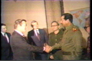 Donald Rumsfeld shakes hands with Saddam Hussein.